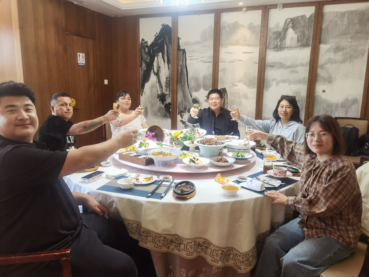 Tavol and Peruvian dealer team at dinner after the factory visit