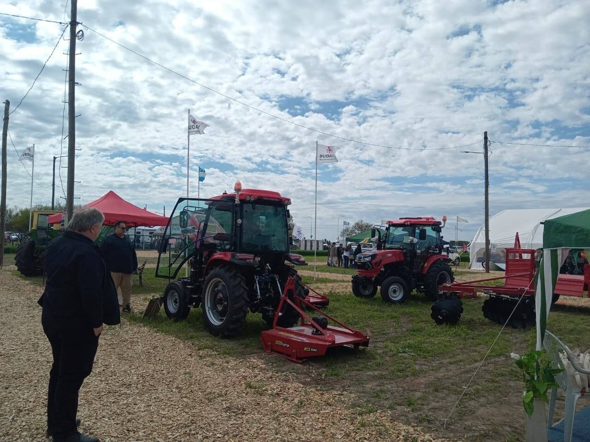 TAVOL tractors with a rotary grass cutter and farm trailer at a garden machinery exhibition in Argentina